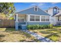 Quaint blue bungalow with a welcoming front porch and well-kept lawn at 2720 14Th N Ave, St Petersburg, FL 33713