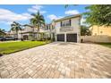 Charming two-story home with a spacious brick driveway and a beautifully landscaped front yard at 3903 W De Leon St, Tampa, FL 33609