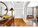 Bright foyer with hardwood floors, a decorative table, and a view into the living area at 3903 W De Leon St, Tampa, FL 33609