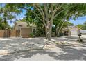 Charming single-story home featuring a gravel yard, mature trees, and detached garage at 4021 Vana Dr, Sarasota, FL 34241