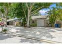 Cozy home with concrete driveway, single car garage, and lush landscaping at 4021 Vana Dr, Sarasota, FL 34241