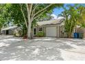 Cozy home with concrete driveway, single car garage, and lush landscaping at 4021 Vana Dr, Sarasota, FL 34241