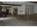 Spacious living room with wood beams, ceiling fan, and partial wall framing at 4673 Dewey Dr, New Port Richey, FL 34652