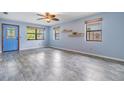 Bright living room with blue walls, modern flooring, ample natural light, and a stylish blue front door at 507 4Th Sw Ave, Largo, FL 33770