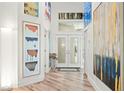 Bright foyer with hardwood floors, high ceilings, and decorative artwork at 5102 White Pine Ne Cir, St Petersburg, FL 33703