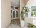 View of the home's entryway featuring double doors, tile flooring, and ample natural light at 5102 White Pine Ne Cir, St Petersburg, FL 33703