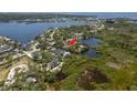 Aerial view featuring the home, nestled along the water, highlighted by a red arrow at 5270 Miller Bayou Dr, Port Richey, FL 34668