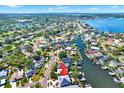 Aerial view of a charming waterfront home with solar panels surrounded by lush trees and water access at 5331 Bayou Grande Ne Blvd, St Petersburg, FL 33703