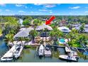 Waterfront home with boat dock, swimming pool, lush greenery, perfect for outdoor enjoyment and relaxation at 5331 Bayou Grande Ne Blvd, St Petersburg, FL 33703