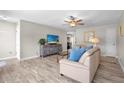 Bright living room featuring wood-look flooring, comfortable furniture, a ceiling fan, and lots of natural light at 6006 114Th N Ter, Pinellas Park, FL 33782