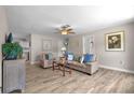 Inviting living room with wood-look flooring, neutral walls, ceiling fan, and comfortable seating arrangement at 6006 114Th N Ter, Pinellas Park, FL 33782