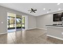 Open floor plan featuring living room with ceiling fan and sliding door leading to patio at 6924 Towne Lake Rd, Riverview, FL 33578