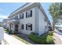 Charming exterior of home featuring two-story architecture, lush landscaping, and neutral color palette at 6960 Sunset S Dr # 2B, South Pasadena, FL 33707