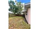Backyard featuring a wood fence and mature trees providing shade at 72 Lake Shore Dr, Palm Harbor, FL 34684