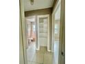 Hallway view showing a linen closet, and access to a bathroom and bedroom at 72 Lake Shore Dr, Palm Harbor, FL 34684