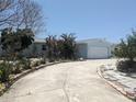 Inviting single-story home with a circular driveway and partial landscaping at 7832 3Rd S Ave, St Petersburg, FL 33707
