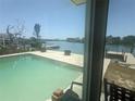Backyard pool view of the canal and neighborhood from the sunroom window at 7832 3Rd S Ave, St Petersburg, FL 33707