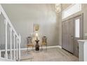 Spacious foyer featuring a soaring ceiling, decorative lighting, tile flooring, and a view of the entryway at 9322 Via Segovia, New Port Richey, FL 34655