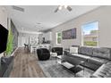 Open-concept living room with hardwood floors, comfortable seating, and large windows for natural light at 1006 E 23Rd Ave, Tampa, FL 33605