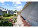 Sidewalk view leading to the entrance, adorned with tasteful landscaping at 11363 Cocoa Beach Dr, Riverview, FL 33569
