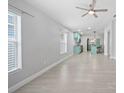 Bright, open-concept living space with modern flooring and a view of the kitchen at 11363 Cocoa Beach Dr, Riverview, FL 33569