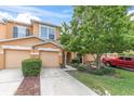 Charming townhome showcases a well-maintained lawn, lovely tree, and inviting facade at 11615 Mango Ridge Blvd # 39, Seffner, FL 33584