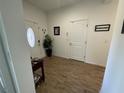 Foyer with tiled flooring, glass accented front door and a decorative plant at 12032 Grand Kempston Dr, Gibsonton, FL 33534