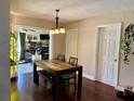Cozy dining area with hardwood floors, modern light fixture, and a wood table, perfect for Gathering meals at 1462 Highfield Dr, Clearwater, FL 33764