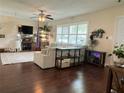 Spacious living room featuring hardwood floors, bright windows, ceiling fan, and comfortable seating area with natural light at 1462 Highfield Dr, Clearwater, FL 33764