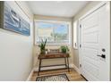 Light and airy entryway with a console table, wood floors, and a front door with sidelight at 1529 Essex N Dr, St Petersburg, FL 33710