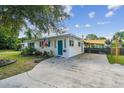 The house has a long driveway leading to a covered parking area with a black fence at 1529 Essex N Dr, St Petersburg, FL 33710