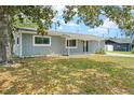 Cozy single-story home with a well-maintained lawn and mature trees in the yard at 1569 Larkin Rd, Spring Hill, FL 34608