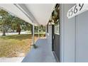 Close-up of a home's charming covered front porch and front door at 1569 Larkin Rd, Spring Hill, FL 34608