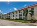 Beautiful building exterior with manicured landscaping and lovely balconies at 2700 Bayshore Blvd # 2110, Dunedin, FL 34698