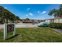 Well-maintained condo buildings with ample parking and verdant landscaping at 2700 Bayshore Blvd # 2110, Dunedin, FL 34698