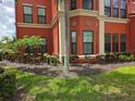 Exterior shot showcasing manicured landscaping and architectural details of the building at 2713 Via Murano # 210, Clearwater, FL 33764