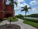 Paver walkway leading to a tranquil waterfront view near the building at 2713 Via Murano # 210, Clearwater, FL 33764