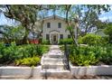 Inviting two-story home with a patterned walkway leading to a beautiful front yard with mature trees at 3011 Harbor View, Tampa, FL 33611