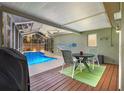 Relaxing screened-in porch with outdoor seating overlooking the sparkling in-ground pool at 3205 Coventry N, Safety Harbor, FL 34695