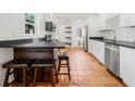 Kitchen boasts stainless appliances, breakfast bar with seating, and sleek black countertops at 3310 W Ballast Point Blvd, Tampa, FL 33611
