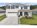 Charming two-story home featuring a neat front lawn, blue shutters, and a cozy front porch seating area at 3739 Capri Coast Dr, Plant City, FL 33565