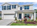 Charming two-story home featuring a neat front lawn, blue shutters, and a cozy front porch seating area at 3739 Capri Coast Dr, Plant City, FL 33565
