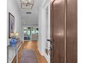 Elegant entryway featuring hardwood floors, a decorative rug, and a view into the open living space at 3809 W San Pedro St, Tampa, FL 33629