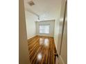 Comfortable bedroom with neutral walls, laminate flooring and a large window with blinds at 4207 S Dale Mabry Hwy # 9106, Tampa, FL 33611