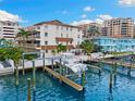Waterfront condo building with a private boat lift and dock overlooking blue water at 479 E Shore Dr # 5, Clearwater, FL 33767