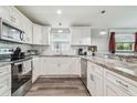 Well-lit kitchen with stainless steel appliances, granite countertops, and ample cabinet space at 4802 18Th St, Zephyrhills, FL 33542