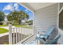 Inviting porch featuring blue Adirondack chairs with a view of the neighborhood at 4802 18Th St, Zephyrhills, FL 33542