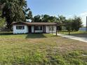 Quaint single-story home with a long driveway and a well-maintained lawn, showcasing suburban charm at 502 Johnson Rd, Plant City, FL 33566