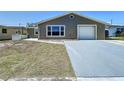 A charming single-story home featuring an attached garage, a neutral color scheme, and a concrete driveway at 5139 Victoria Ln, Holiday, FL 34690