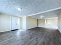 Spacious living room featuring modern flooring, fresh paint, and ample natural light from the front door at 5139 Victoria Ln, Holiday, FL 34690